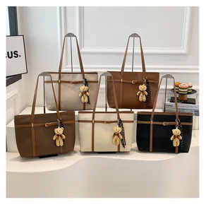 Collection of stylish faux leather tote bags in five neutral colors with cute charms.