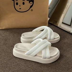 Close-up of cream platform sandals with cross-strap design in a lifestyle setting