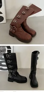 Detailed close-up of stylish black and brown multi-buckle biker boots for women.