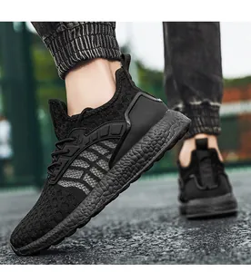 Close-up of black flyknit running shoes showing breathable mesh and textured foam sole