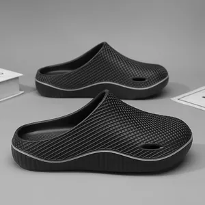 Black non-slip closed-toe work slippers for men with textured grid pattern design