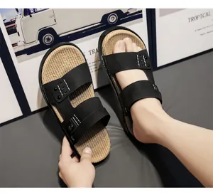Close-up of men's black dual-strap sandals with woven textured insole for beach wear.