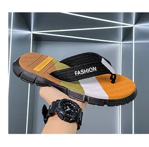 Detail view of men's non-slip beach flip-flops with camouflage patterned footbed