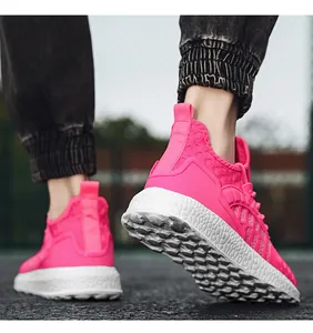 Detailed view of vibrant pink knit running shoes with textured white soles