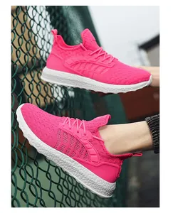 Detailed view of neon pink flyknit mesh running shoes featuring a thick white foam sole.