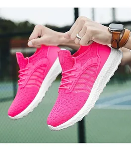 Close-up of vibrant pink breathable mesh running shoes with white textured soles