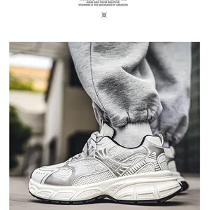 Close-up of stylish white and silver chunky sneaker featuring breathable mesh and leather