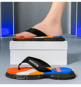 Macro view of men's non-slip sports flip-flops with vibrant orange and blue design details