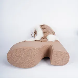 Detail view of anti-slip textured sole on brown platform winter boots for women