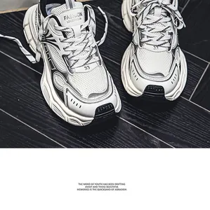 Macro view of stylish white and black chunky dad sneakers on wooden floor