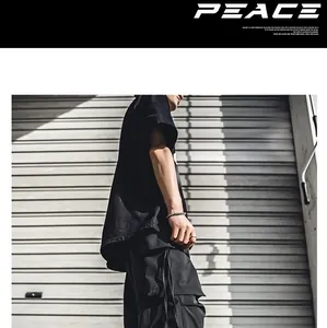 Detailed side view of black streetwear cargo pants and tee against textured shutter.
