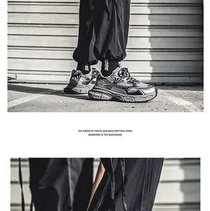 Macro view of trendy silver and black men's dad shoes featuring thick soles for street style