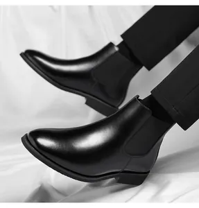 Close-up of black leather Chelsea boots showing sleek texture and elegant ankle fit.