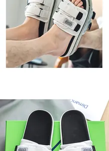 Detail shot of white men's sports slides featuring adjustable Velcro straps and labels