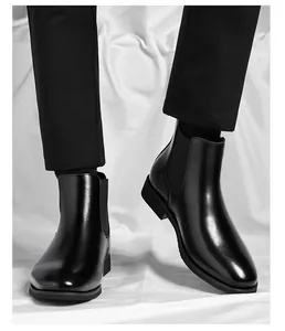 Close-up of men's black Chelsea boots in a classic British retro style leather finish.