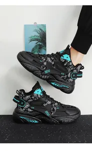 Detail view of black high-top sneakers with turquoise bandana patterns and chunky soles.