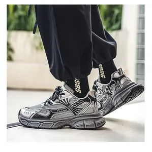 Side view detail of silver and black metallic chunky dad sneakers in street style wear