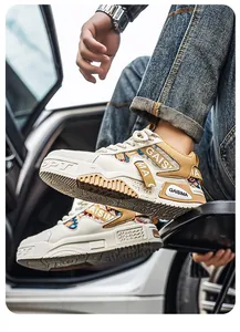 Close-up detail of premium men's chunky dad sneakers with ethnic patterns and beige tones.