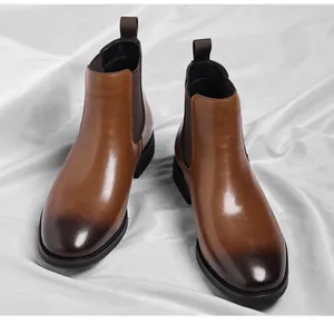 Detailed view of men's brown British retro Chelsea boots with a burnished toe finish