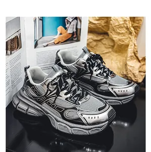 Detailed view of trendy silver and black chunky sneakers with mesh design panels