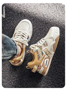 Close-up detail of stylish khaki and white outdoor chunky sneakers with colorful patterns.