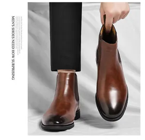 Detailed view of brown leather Chelsea boots with elegant burnished toe and elastic side