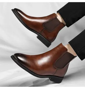 Detailed side view of vintage brown leather Chelsea boots for men with elastic panels