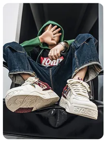 Modern streetwear chunky dad sneakers in cream white with rugged soles shown on model