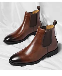 Detailed side view of classic brown burnished leather Chelsea boots for men in a white setting.