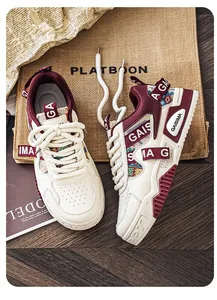 Close-up of cream and burgundy men's chunky sneakers featuring colorful knit accents