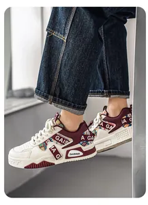 Detailed view of men's chunky sneakers with burgundy accents and ethnic patterns.