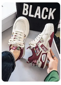 Close-up view of men's chunky dad sneakers with burgundy and camouflage accents