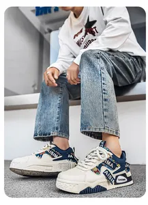Lifestyle shot of men's white and navy chunky sneakers with camouflage webbing details.