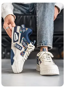 Close-up of men's chunky sneakers with ethnic pattern and navy blue accents.