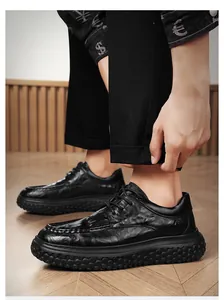 Detailed side view of black waterproof non-slip men's work shoes with textured leather