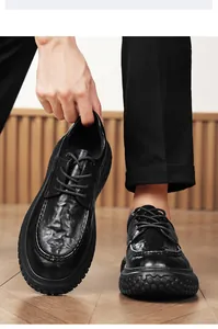 Detail of black non-slip work shoes for men showing textured leather and sturdy soles