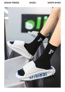 Close-up detail of white men's sport slides featuring a thick soft sole and blue accents