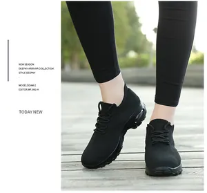 Gros plan de baskets noires en maille avec coussin d'air pour femmes sur une terrasse.