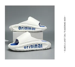 Detail view of white and blue chunky sport slides with side textured thick sole