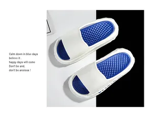 Close-up view of stylish white and blue sport slides with textured comfort insole