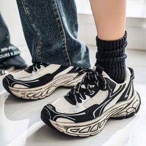 Modern men's black and white chunky dad sneakers featuring thick soles and breathable mesh