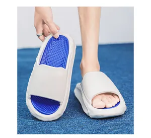 Close-up of grey and blue cushioned slides showing the soft textured footbed for men
