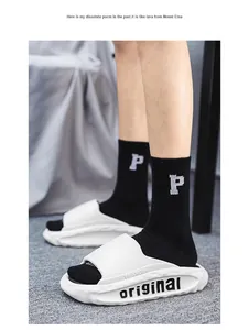 Detail view of white cloud-feel slides with original text on thick soft soles