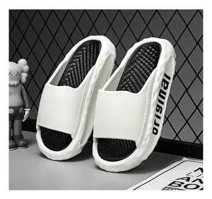 Detailed macro view of white sports slides with thick soft soles against a grid background
