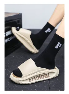Close-up view of beige men's sporty slides featuring TRANCE and original side lettering