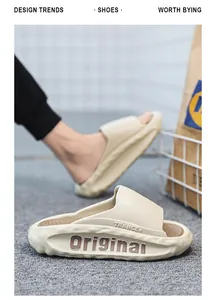 Side view of beige thick-soled slides with 'Original' embossed lettering