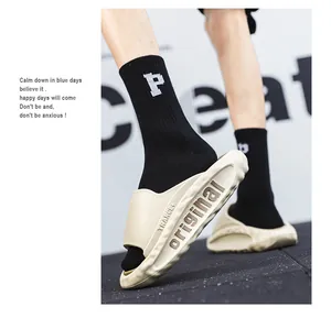Detail view of beige soft-sole sports slides featuring thick original lettered design