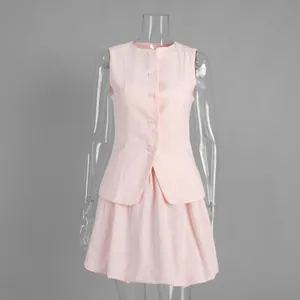 Elegant pink sleeveless waistcoat and matching tulip mini skirt set on clear mannequin