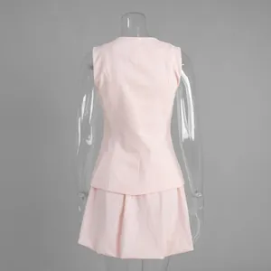 Back view of pink sleeveless vest and tulip skirt two-piece set displayed on mannequin.