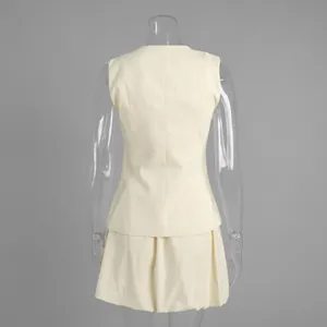 Back view of a chic cream-colored vest and bubble mini skirt set for summer fashion